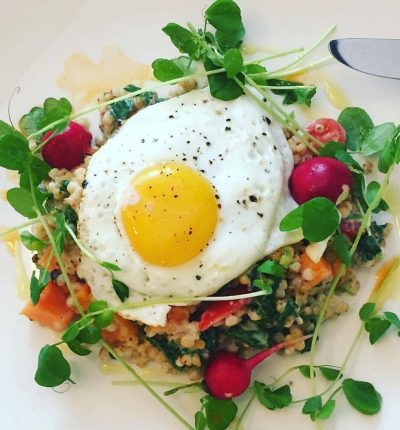 Sorgum grain and quinoa salad topped with an egg